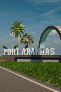 the sign for port aranasas is in front of some palm trees and green grass