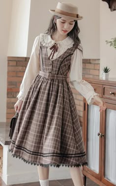 Plaid pinafore dress with a v-neckline, button down front, belted waist and midi skirt with black lace trims. Concealed side zipper. Matching blouse available with a peter pan collar, lace trims and neck detail.  BlouseS: 14.5” across shoulders, 35" chest, 22" lengthM: 15” across shoulders, 36.5" chest, 22" lengthL: 15 Plaid Pinafore Dress, Vintage Pinafore Dress, Dark Academia Dress, Vintage Pinafore, Midi Dress Brown, Wardrobe Revamp, People Reference, Diy Lipstick, Elegant Clothing