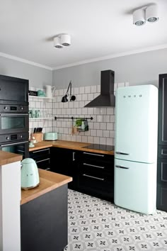 a white refrigerator freezer sitting inside of a kitchen