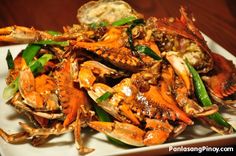 a pile of cooked crabs on a white plate