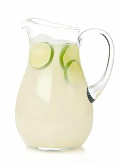 a pitcher filled with liquid and lime slices