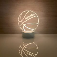 a light up basketball is sitting on the floor next to a lamp that says, daniel