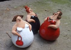 three ceramic figurines sitting on top of each other