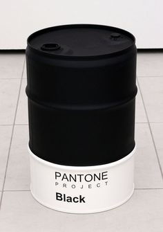 a black and white container sitting on top of a tile floor