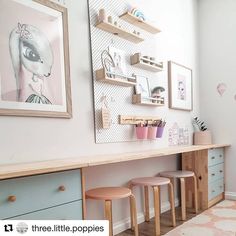 a child's room with two desks and three stools in front of it