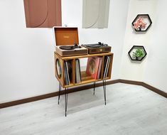 a record player sitting on top of a wooden shelf