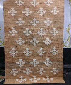 an old rug with white crosses on it