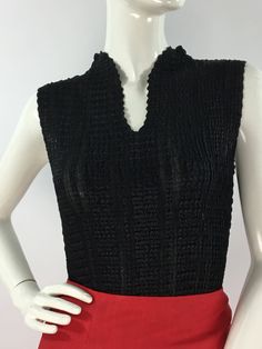 "Vintage black Nicola sleeveless top, size equivalent to medium/large  Measurements:  Shoulder outer seam-seam 13\"/bust 15\"-24\"/length 22\" Material will stretch several inches  Mannequin measurements:  5'8\", bust 34\", waist 25\", hip 33\" Please note that vintage clothing sizes can vary greatly.  The Measurements provided  are approximate and are taken lying flat.  I suggest taking a similar garment from your wardrobe and measure it while lying flat.  This way you can compare measurements. Vintage Stretch V-neck Top, Black V-neck Vest For Night Out, Retro V-neck Fitted Vest, Black Fitted Tank Top, Black Sleeveless Vest Top, Fitted Black Knit Tank Top, Fitted Black Tank Top, Retro V-neck Vest Tops, Black V-neck Summer Vest