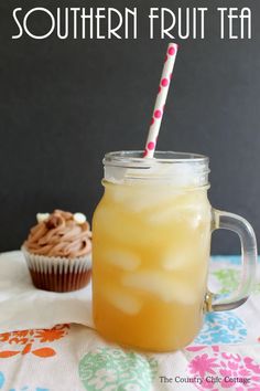 a cupcake sitting next to a mason jar with a straw in it and the words southern fruit tea