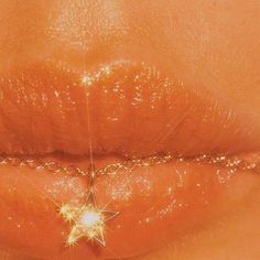 a woman's lip is shown with sparkles on the top and bottom of it