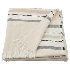 a white and grey striped blanket folded on top of each other with fringes around the edges