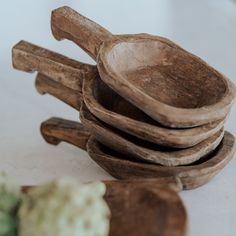 a stack of wooden spoons sitting next to each other on top of a table