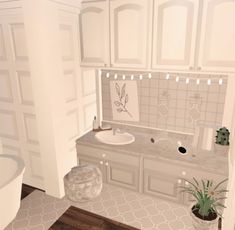 a bathroom with white cabinets and wood floors