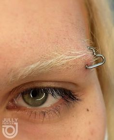 a close up of a person with an eye piercing