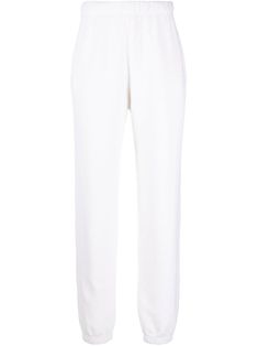 Vintage white cotton tapered-leg track pants from RE/DONE featuring mid-rise, elasticated drawstring waistband, two side slit pockets and elasticated cuffs. POSITIVELY CONSCIOUS: This Planet Conscious product is crafted from certified recycled or upcycled materials, which helps you make a better choice for the environment as they generate less energy, save water and reduce the need for new raw materials. For recycled synthetic clothing products we highly recommend using a microfibre-catching was Upcycled Materials, Save Water, Wash Bags, Drawstring Waistband, Sport Pants, Active Wear For Women, Tapered Legs, Track Pants, White Cotton