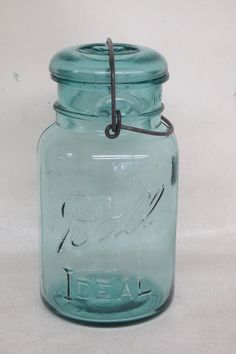 a blue glass jar with a metal clip