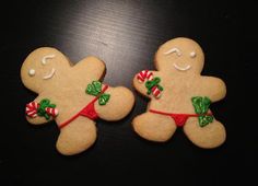 two decorated gingerbreads sitting next to each other