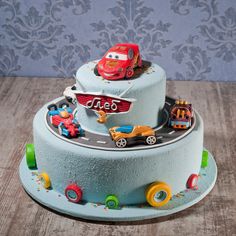 a blue cake with cars and trucks on it