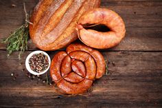 some sausages and other food on a wooden table