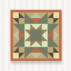 an orange, green and brown quilt with geometric shapes on the bottom half of it