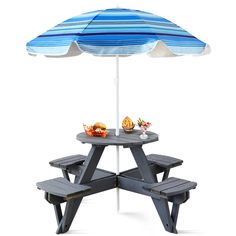 a picnic table with an umbrella over it and some food on the plate under it