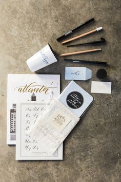 the contents of an allure kit laid out on top of each other, including brushes and eyeliners