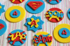 decorated cookies with the word mom spelled in blue and yellow icing on a tablecloth