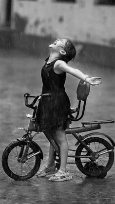 a woman on a bike in the rain