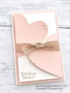 a card with a heart on it and a ribbon tied around the front of it