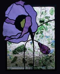 a stained glass window with a purple flower on it