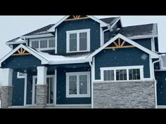 a blue house with snow on the ground