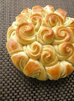 a pastry with spirals on top sitting on a table