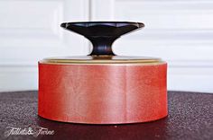 a red canister sitting on top of a wooden table