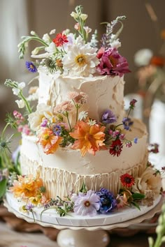 a three tiered cake with flowers on it