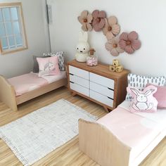 a dollhouse bedroom with two twin beds, dresser and toy animals on the wall