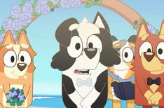 three cartoon dogs standing next to each other in front of an arch with flowers on it