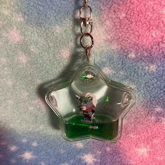 a glass keychain with a cartoon character on it