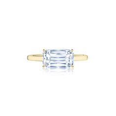 an 18k yellow gold ring with a baguette cut diamond