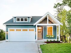 a blue and white house with two garages