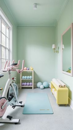 a room with exercise equipment and yoga mats