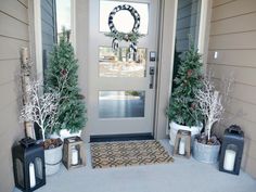 three christmas trees are on the front porch