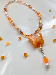 The Chroma Collection features 6 different necklaces! This necklace is adorned in a beautiful  collection of orange, white, and silver beads. it features a lovely hanging butterfly charm. All of my beaded necklaces are assembled by hand with love and are designed to be a unique look for whoever wears it! Art and beauty is for everyone. Thank you for visiting my garden. <3 Luxury Spiritual Orange Beaded Necklace, Luxury Orange Spiritual Beaded Necklace, Orange And Purple Jewerly Beads, Orange Beaded Necklaces With Lobster Clasp, Orange Beaded Dangle Necklaces, Butterfly Charm Necklaces With Round Beads For Gifts, Butterfly Charm Necklace With Round Beads For Gift, Beaded Butterfly Necklace With Round Beads As A Gift, Orange Beaded Pendant Necklace