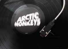 an old record player with the word arctic monkeys on it's side next to a turntable