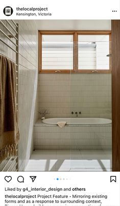 a bathroom with a bathtub and two windows