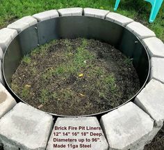 a brick fire pit sitting on top of a lush green field