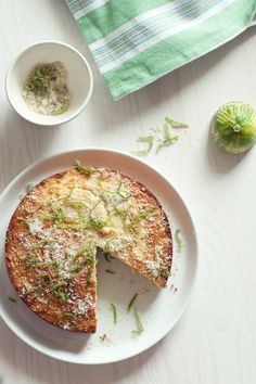 a white plate topped with a cake covered in powdered sugar