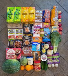 an assortment of food is laid out on the ground next to some fruit and vegetables