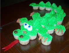 some cupcakes with green frosting on a table