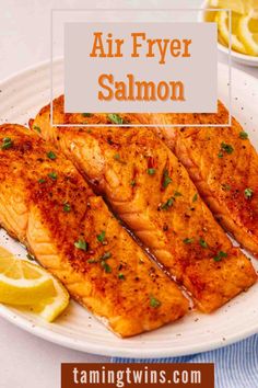 air fryer salmon on a plate with lemon wedges