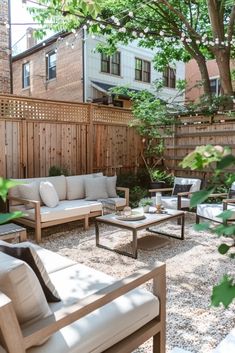 an outdoor living area with couches, chairs and tables in the middle of it